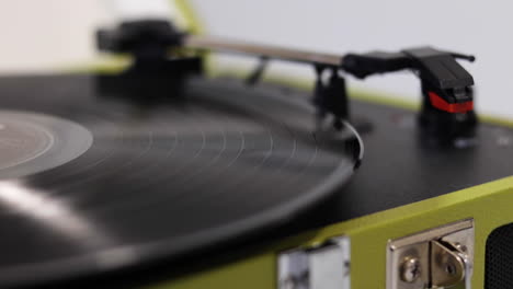 a record-vinyl being placed on a turn table but not turned on