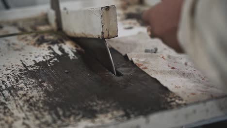 craftsman hand cutting jade stone, close up view