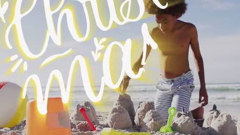 animación de felicitaciones de navidad texto sobre niño afroamericano en la playa