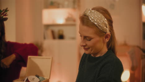 woman wrapping gift boxes with female friends