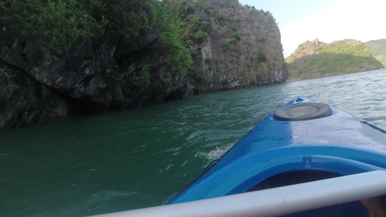 Kayaking around limestone island in Halong Bay Vietnam. Activity part of an overnight boat cruise.