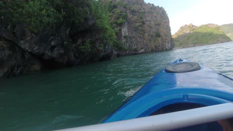kayaking around limestone island in halong bay vietnam. activity part of an overnight boat cruise.