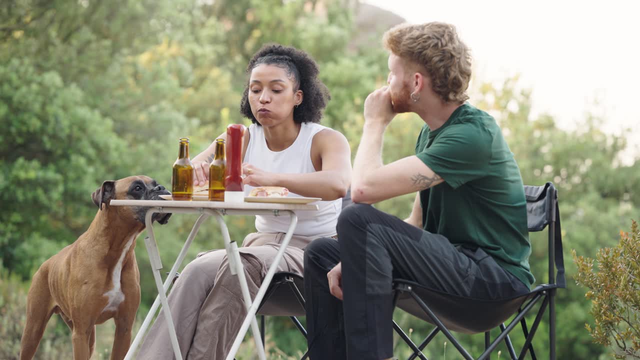 Couple having a picnic with their dog