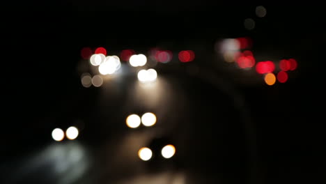 blurred city traffic lights from cars on the freeway