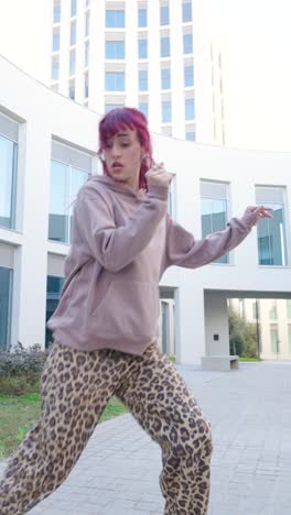 young urban dancer performing outside modern building