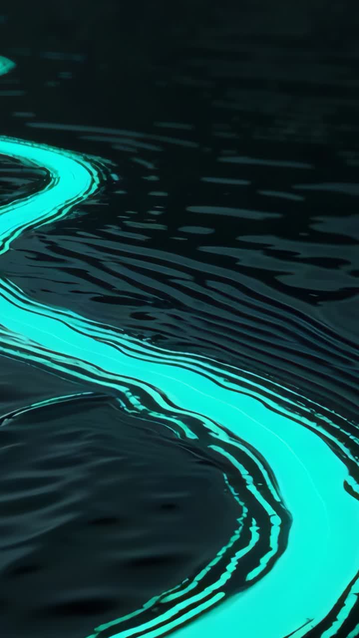 Vertical video: Entering frame, glowing turquoise fluid ribbon drifting across water making ripples