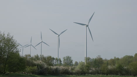 windmill turbines in nature landscape producing clean energy, left pan