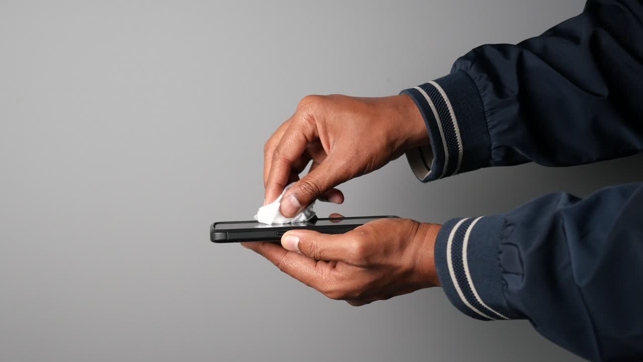 Cleaning a smartphone screen with a wipe