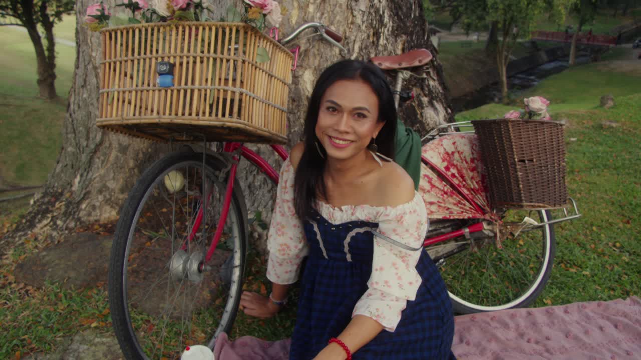 Woman relaxing on a vintage bicycle in a park