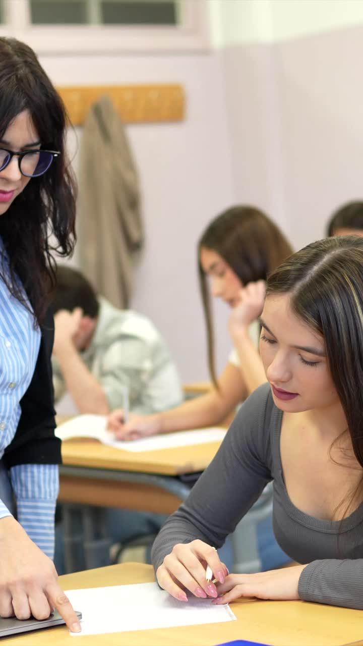 Students in a classroom setting with a teacher supervising