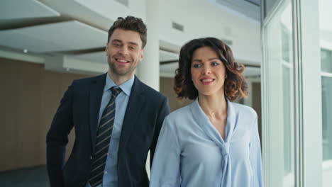 two managers going office corridor closeup. successful business people walking