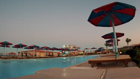 Timelapse-of-the-Sunset-on-the-Beach-With-Umbrellas-and-Beach-Chair-With-Sea-Beach-Background-Pool-by-Amazing-Sunset-View