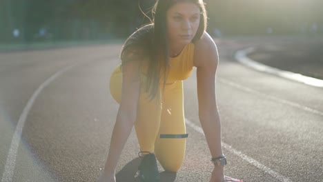 woman jogging on outdoor track in sportswear at athletic field