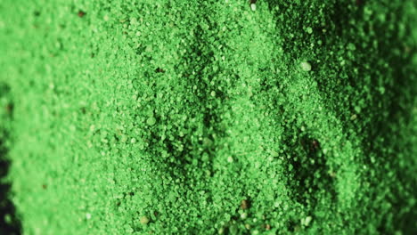 video of close up of green powder with copy space on black background