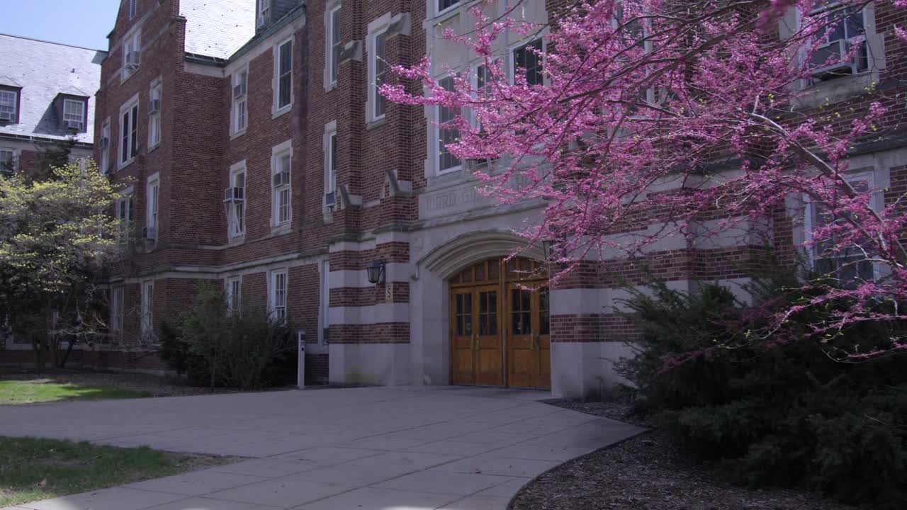 Gilchrist Hall on the campus of Michigan State University in East Lansing, Michigan in the spring with gimbal video moving sideways.