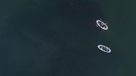 ruins of an underwater lake settlement preserved from the stone sge with two boats on it in koorküla, estonia