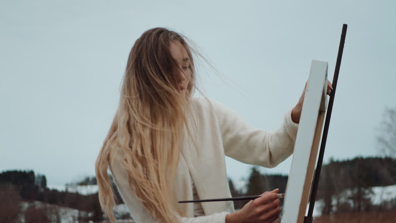 Woman Painting Outdoors in Winter