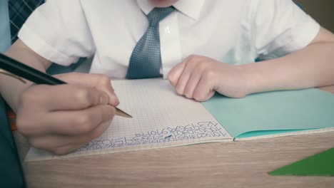 schoolchildren do homework write numbers in notebook helping each other