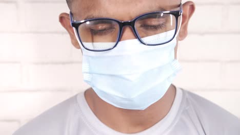 person wearing glasses and a mask