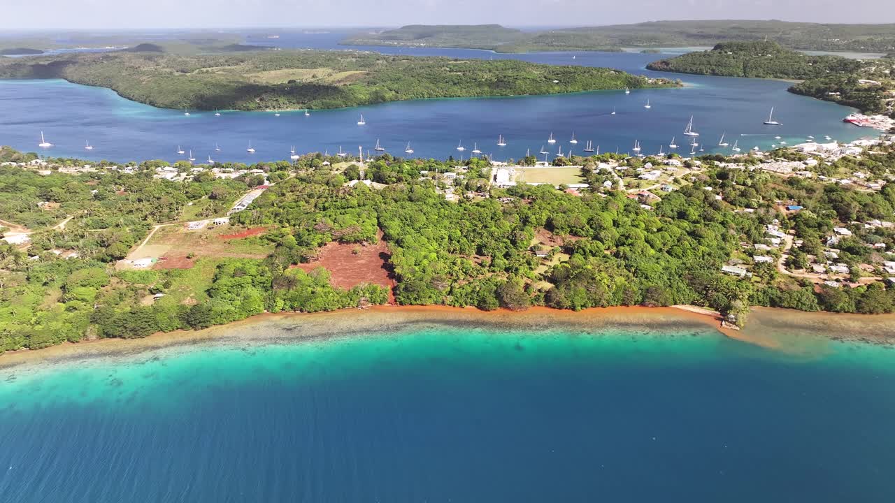 Turquiose water and coral reef Vava'u Island coastal with Neiafu city, Tonga aerial cityscape.