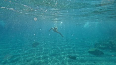 teenager swimming underwater