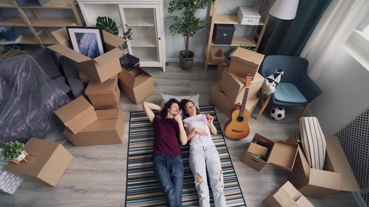 Couple Relaxing Amidst Moving Boxes