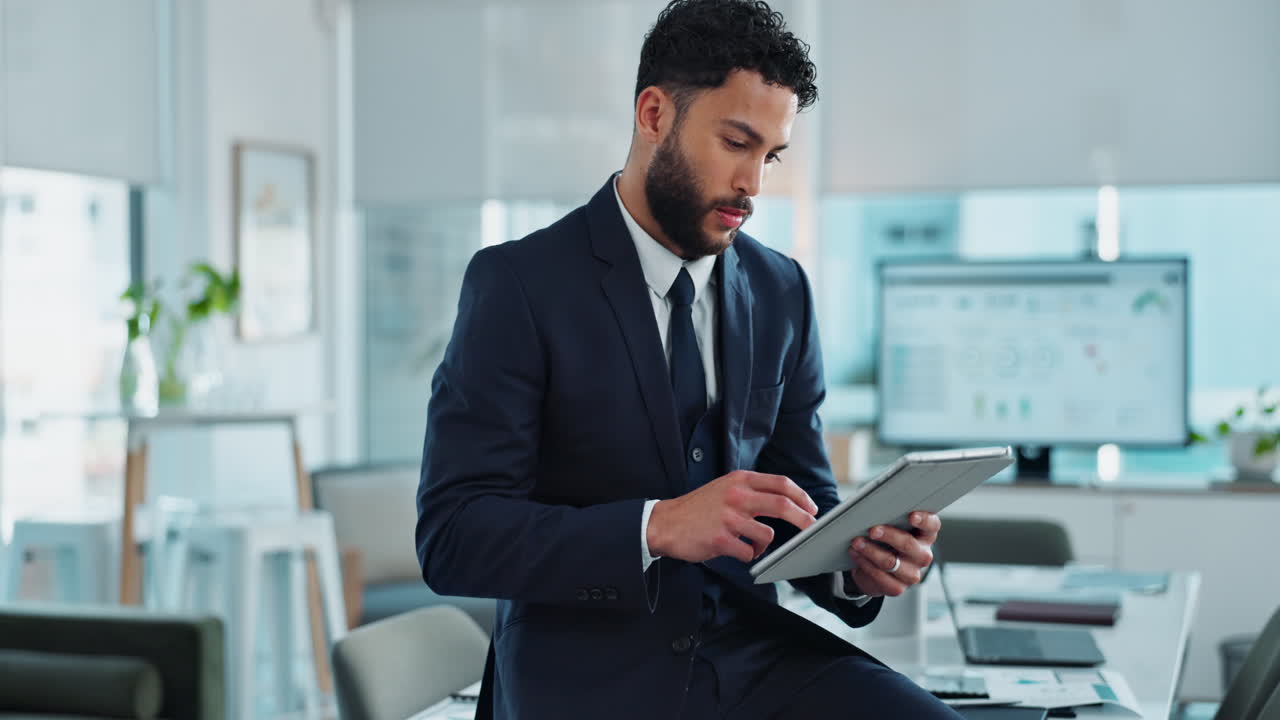 A businessman using a tablet in an office setting