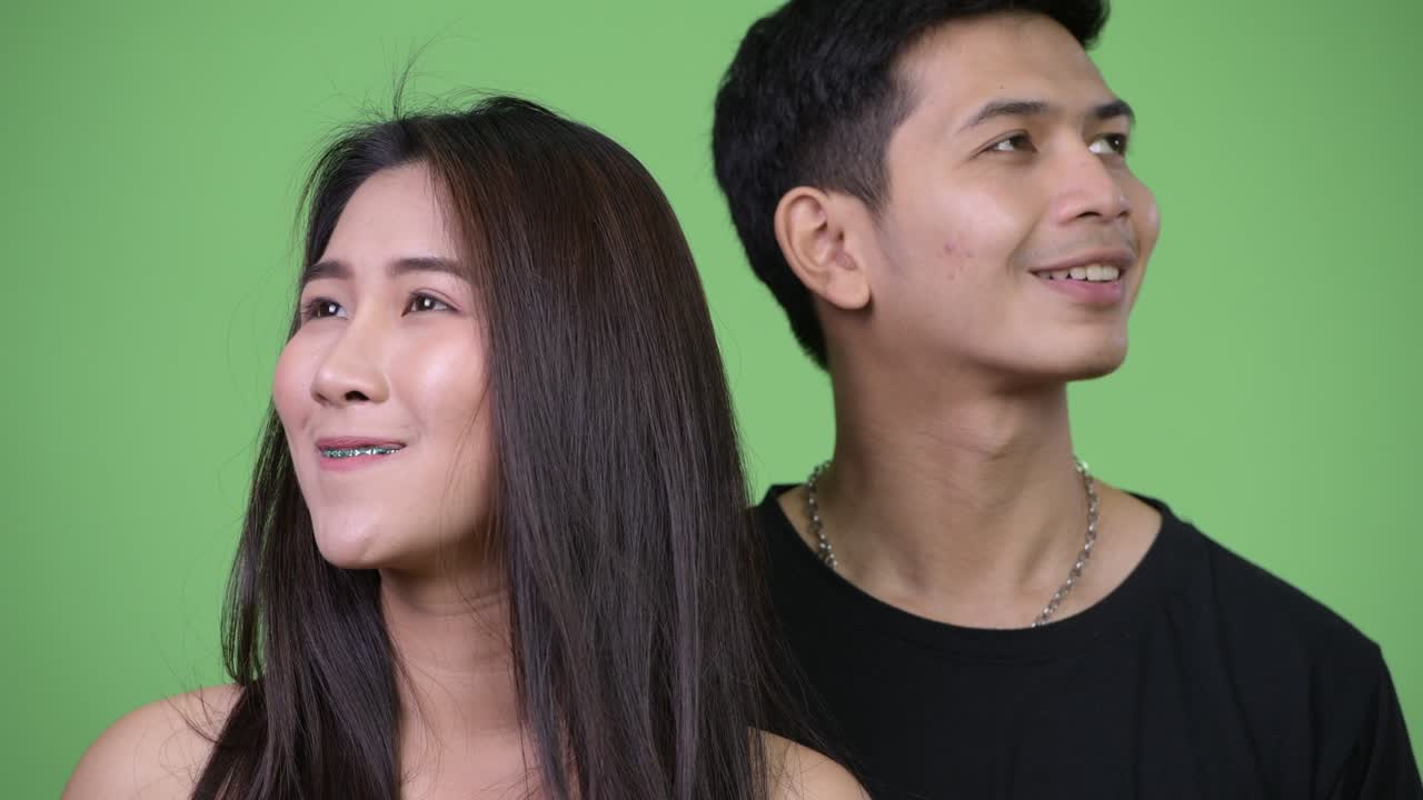 젊은 행복한 아시아 커플이 함께 생각하고 있습니다.