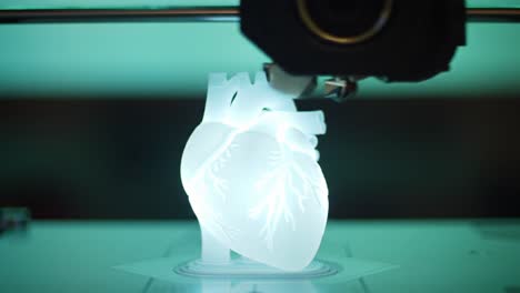 3d printing process captured: a focused look at the creation of an intricate heart model with illuminated detailing and advanced printing technology