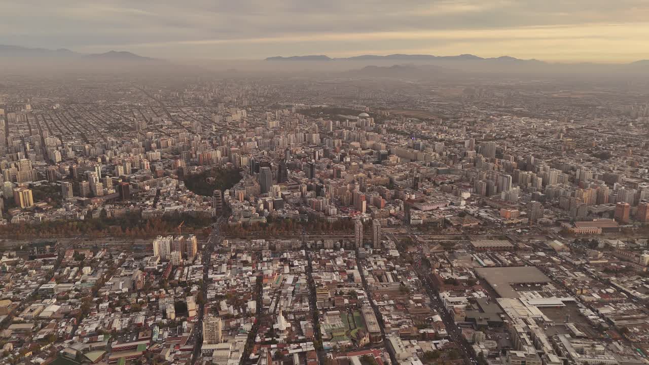 Hovering Cloud of Smog over de Chile City after sunset. Aerial panoramic wide shot. Downtown with skyline and houses. Panning wide shot.