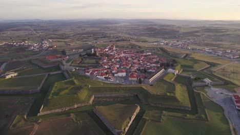 wide shot of medieval town almeida portugal during sunrise with soft light, aerial