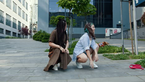 two young women and their dog in a city