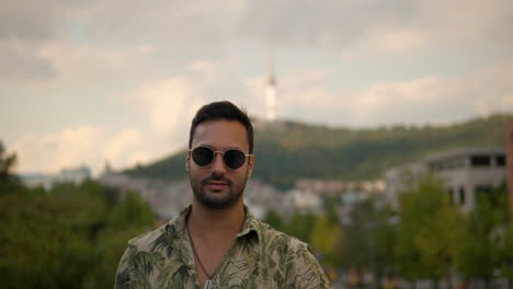 adult man in sunglasses face the camera