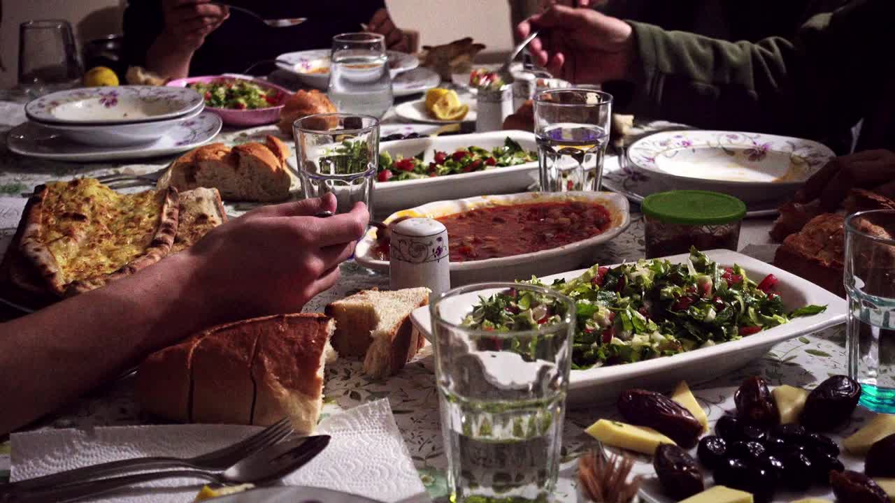 fotografía de una familia musulmana abarrotada comiendo la comida de iftar en el mes sagrado de ramadán