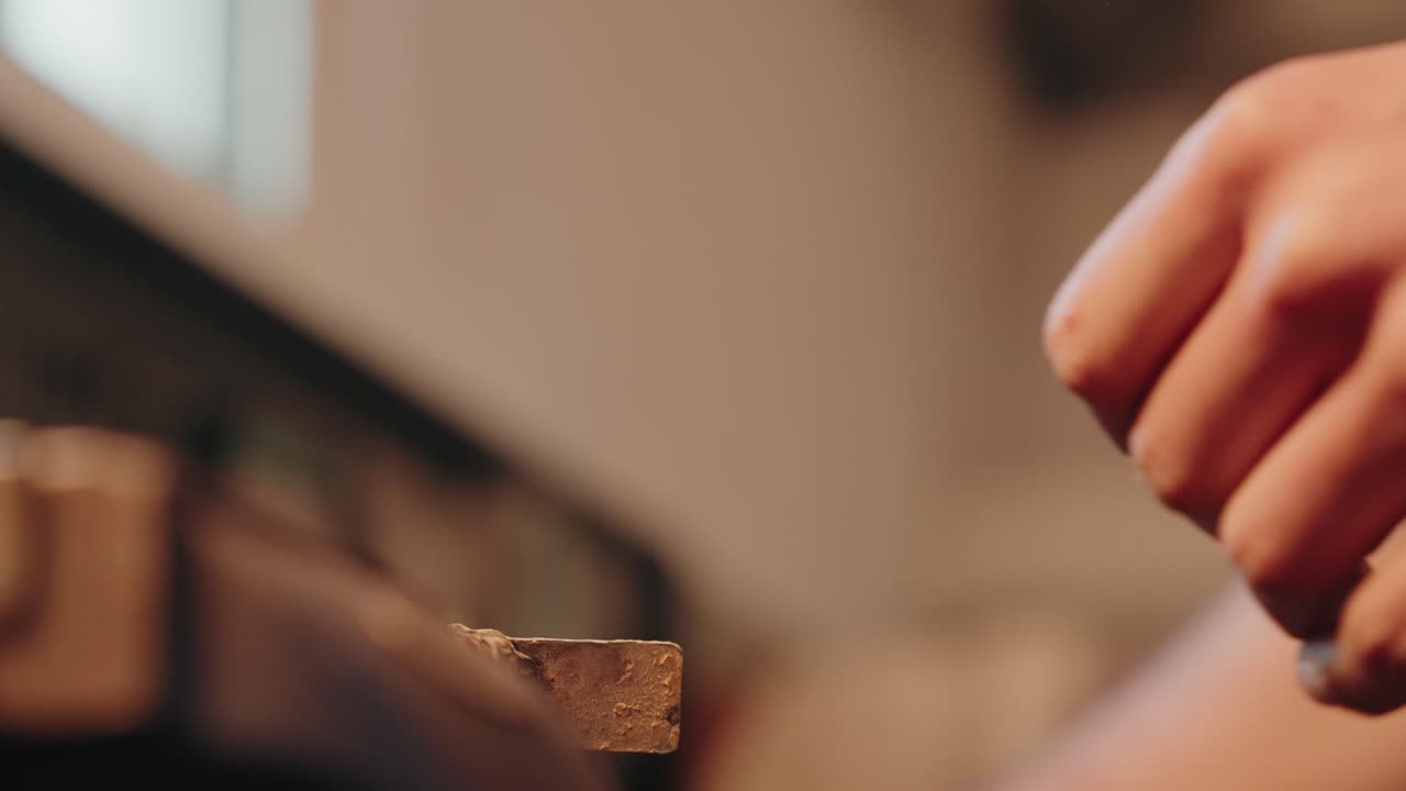 Close up of an angle grinder cutting metal with bright flying sparks in a workshop setting