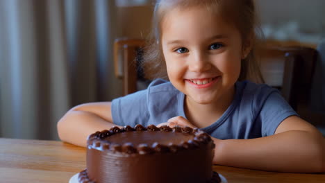 happy little girl with chocolate birthday cake