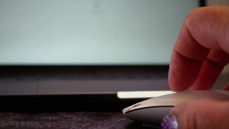 Stylish-woman's-hands-on-a-white-computer-mouse,-scrolling-and-clicking