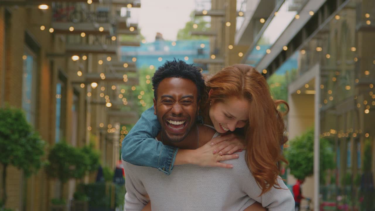 Portrait Of Young Couple Of Vloggers Or Social Influencers Travelling Through City For Social Media