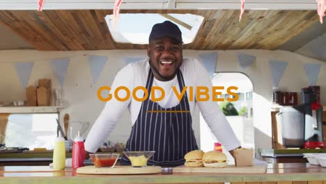 animation of good vibes text with african american man smiling