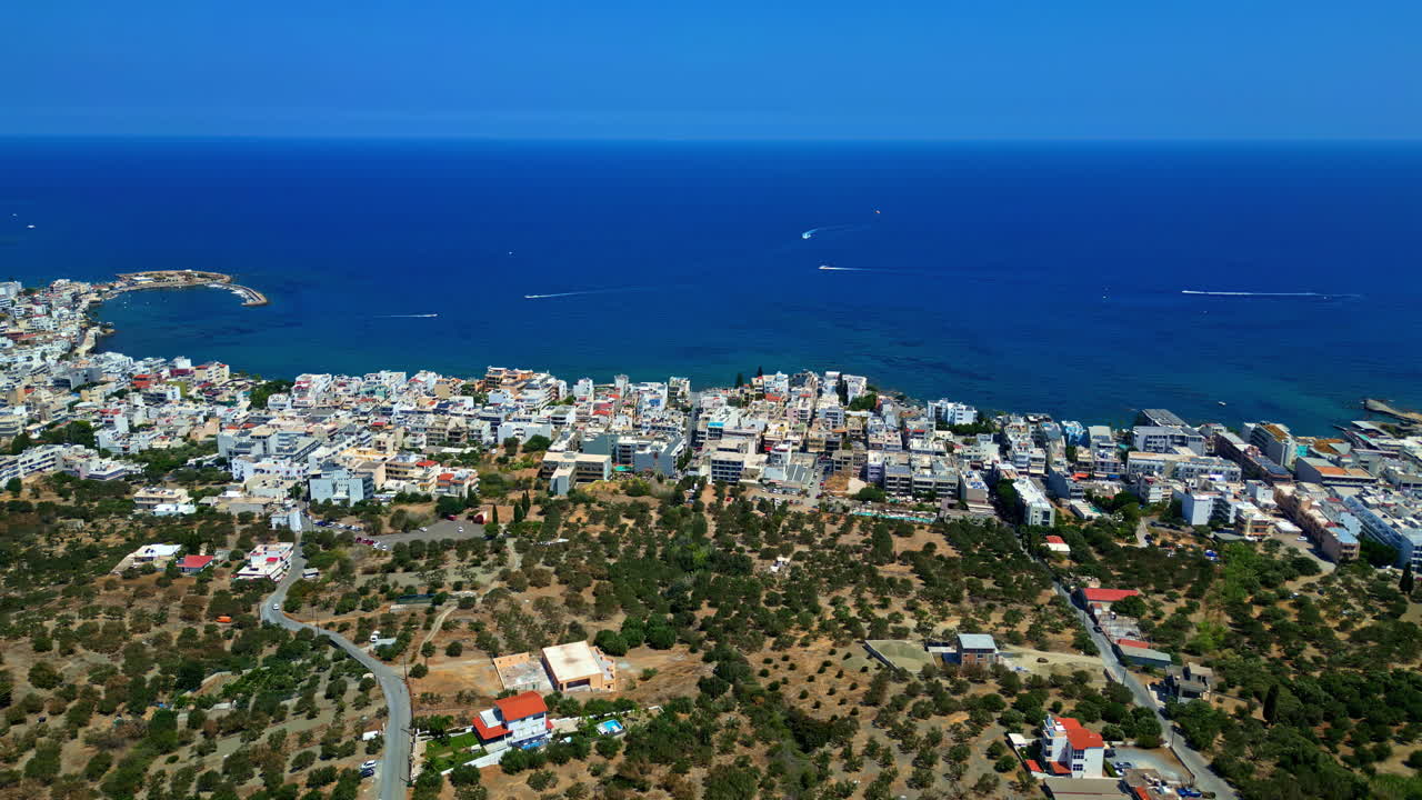Aerial fly blue sea panoramic coastal town, Piskopiano Village in Crete, Greece