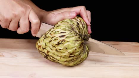 slicing a custard apple to reveal its interior