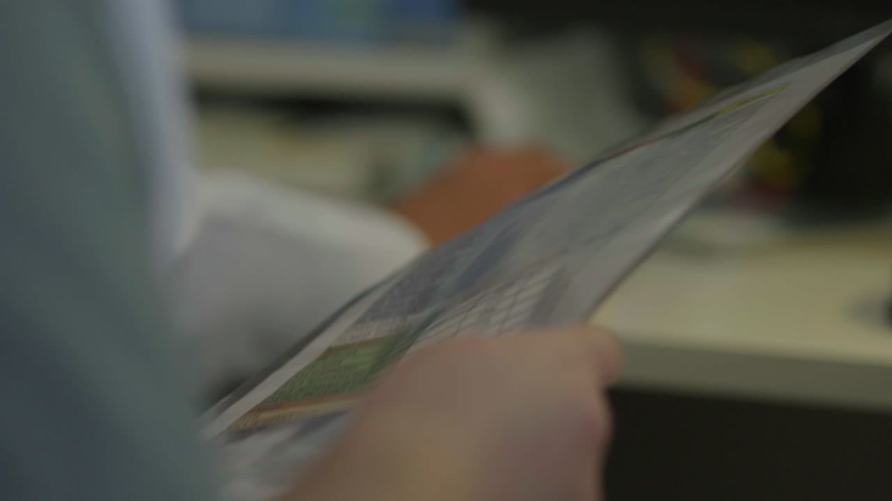 Person Reading Documents in an Office Setting