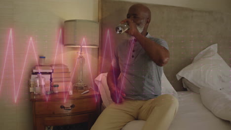 animation of cardiograph over senior biracial man drinking water at home