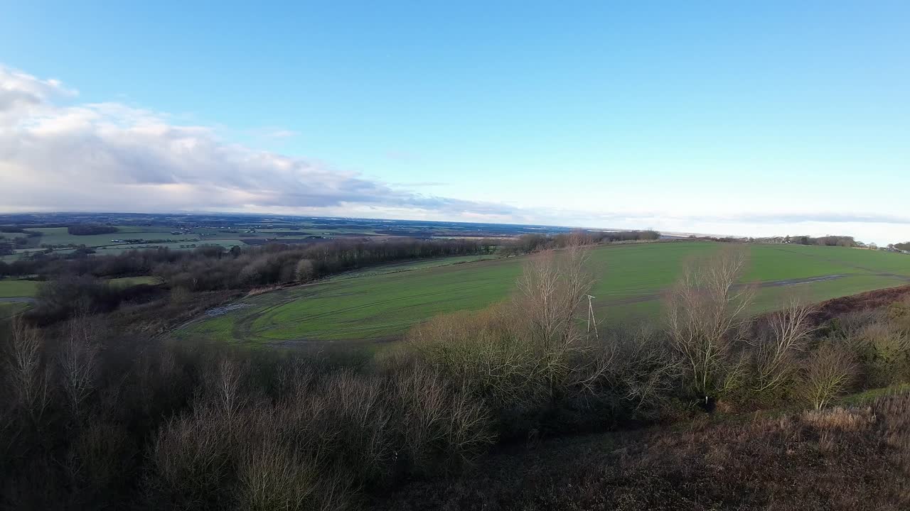 FPV drone flying across Billinge hill beacon autumn Lancashire farmland landscape telephone lines