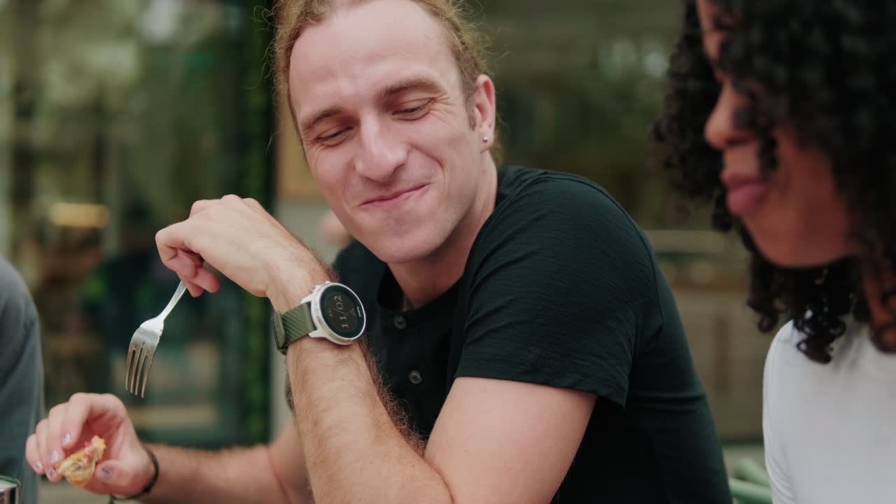 Lunch communication. International friends eating, talking and laughing. Focus