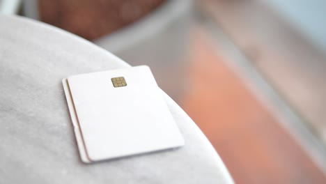 hand holding credit card on a table