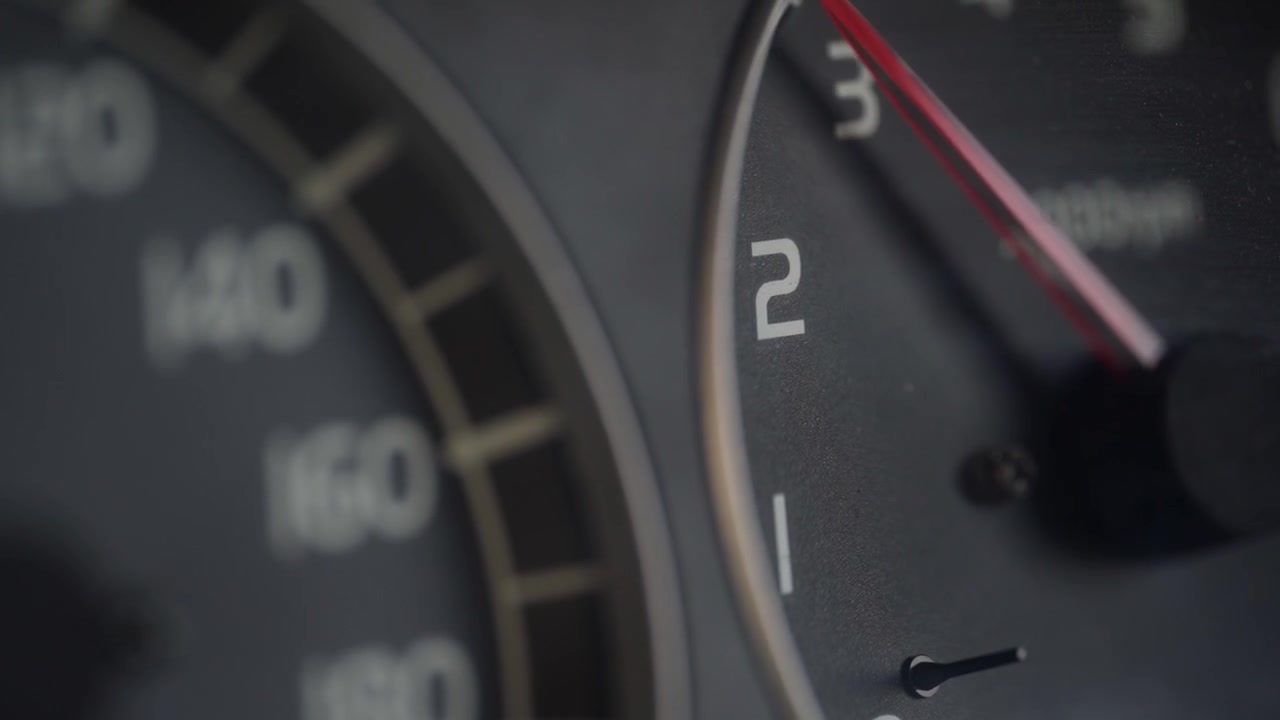 Close-up of a Car Tachometer Needle Rising During Acceleration