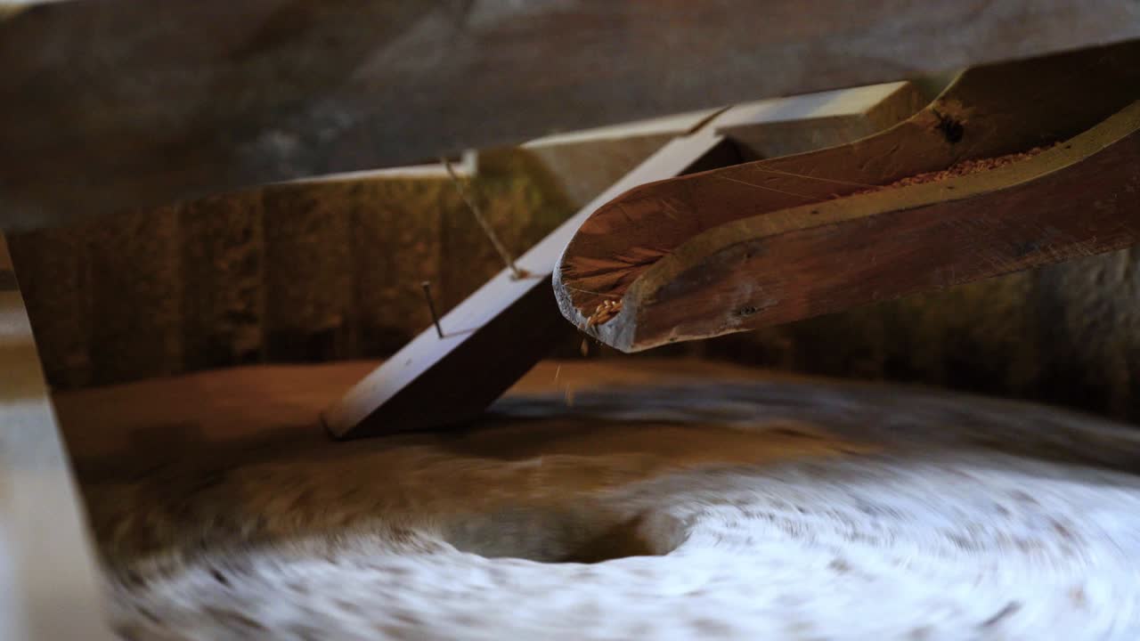 el antiguo molino de grano de piedra gristmill moliendo trigo o granos en harina usando piedra de molino quern piedra en el serbio