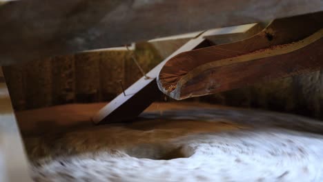 the ancient old stone grain mill gristmill grinding wheat or grains into flour using millstone quern stone in the serbian