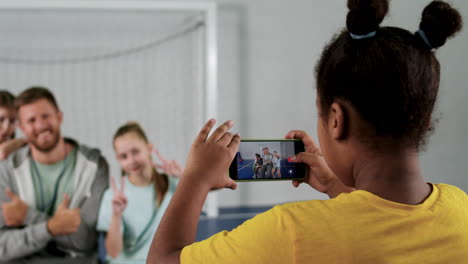 man and kids waving to the phone